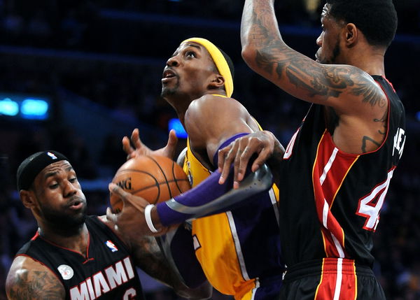 Lakers Dwight Howard attempts a shot on Heats LeBron James, left, and Udonis Haslem at the Staples