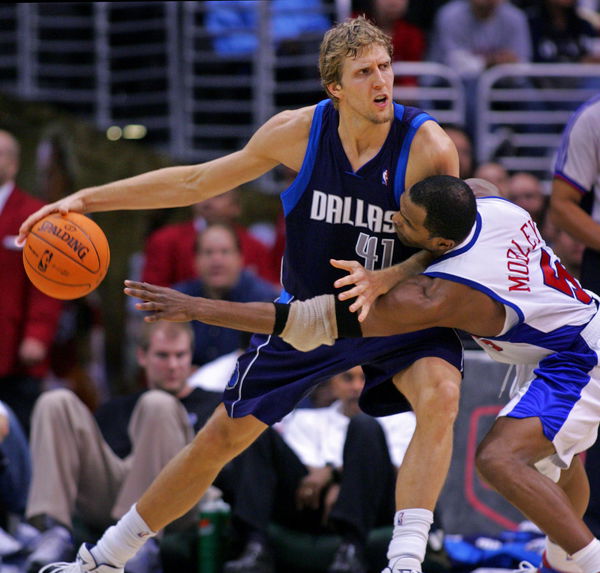 Clipper Cuttino Mobley, right, reaches for the ball as he guards Dallas Maverick Dirk Nowitzki duri