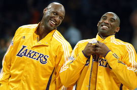 Lakers teammates Lamar Odom and Kobe Bryant share a light moment before the start of a game against