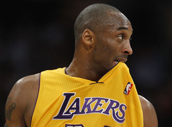 Lakers guard Kobe Bryant chews on his jersey for a few seconds as he runs downcourt against the San