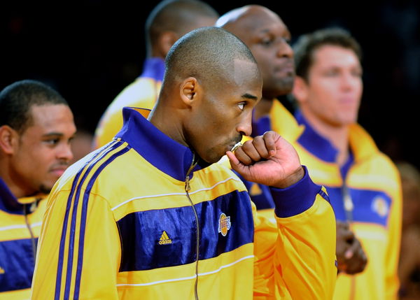 Lakers Kobe Bryant kisses his championship ring during a ceremony at the Staples Center Tuesday.