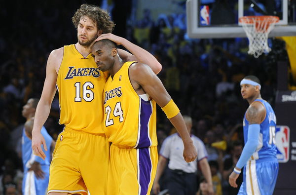 Lakers Pau Gasol hugs Kobe Bryant late in the 4th quarter as Nuggets Carmelo Anthony looks on in Ga