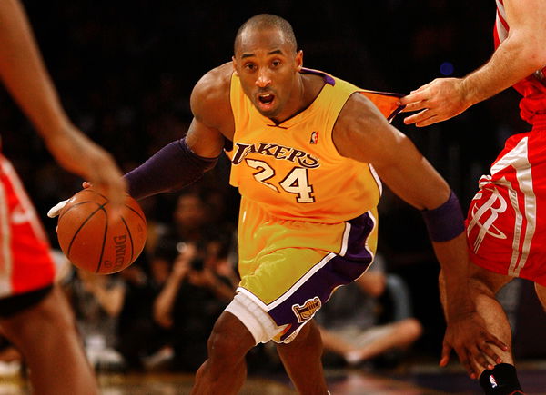 Los Angeles Lakers&#8217; Kobe Bryant goes for the basket while a Houston Rockets player tugs at his jers