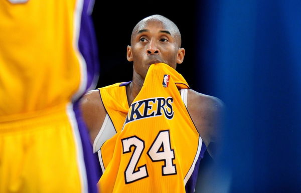 LOS ANGELES, CALIFORNIA JANUARY 29, 2013-Lakers Kobe Bryant bites his jersey while Pau Gasol shoots