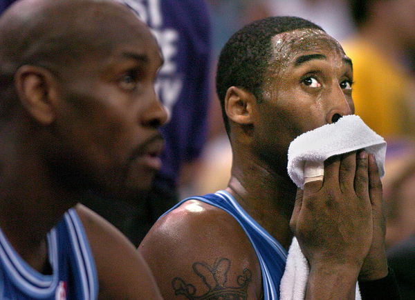 Laker Kobe Bryant, right, watches the scoreboard with Gary Payton against the Sacramento Kings at th