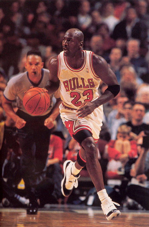 Michael Jordan of the Chicago Bulls jogs up court wearing his