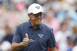 Phil Mickelson reacts to fans on the 2nd green in the second round at the Masters tournament at Augusta National Golf Cl