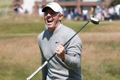 Rory McIlroy Laughing with a Golf Club in Hand