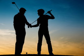RECORD DATE NOT STATED Mature or senior couple playing golf &#8211; pictured as a silhouette against an evening sky, model rel