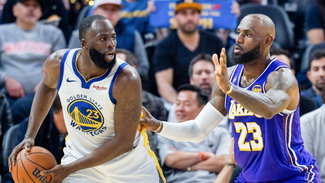 LeBron James gaurding Draymond Green in a game.