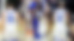 Draymond Green shaking hands with Stephen Curry and Jimmy Butler, as they head to the bench