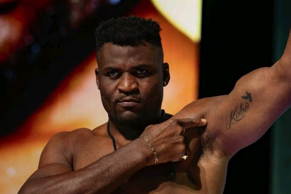 Francis Ngannou shows his tattoo