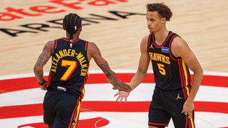 Hawks players Nickeil Alexander-Walker and Dyson Daniels share a moment mid-game