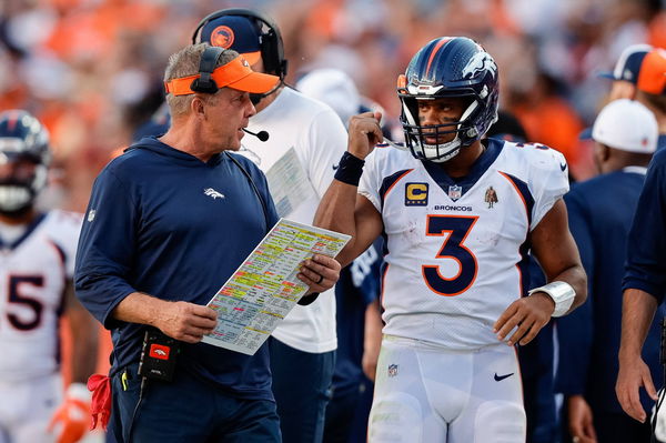 Sean Payton talks with quarterback Russell Wilson