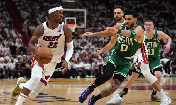 Tyler Herro wears beach outfit on bench during Game 5