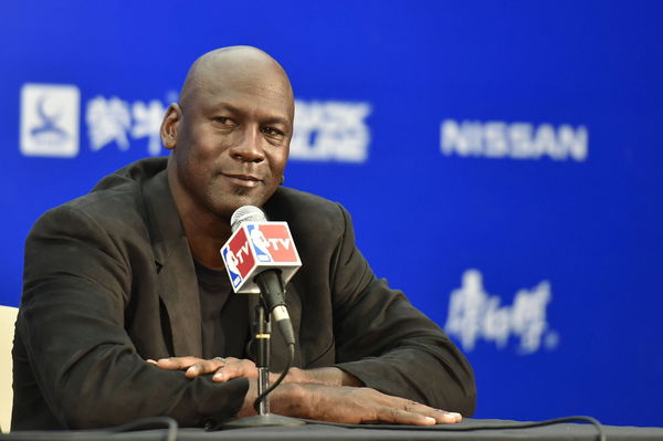 American basketball superstar Michael Jordan, owner and chairman of the Charlotte Hornets, listens at a press conferenc