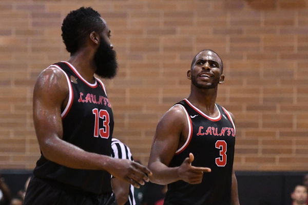 LOS ANGELES CA JULY 30 Houston Rockets guards Chris Paul 3 talks with James Harden 13 during