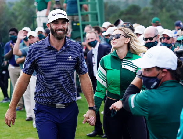 Dustin Johnson and Paulina Gretzky smile as they together walk away from the 18th green after the final round of the 202