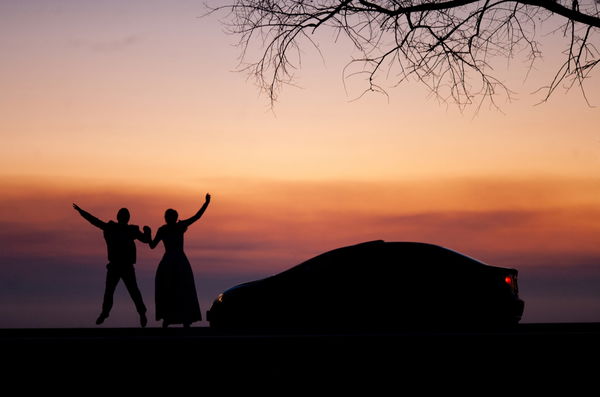 Ailhouette of a wedding couple in love at sunset near the car., silhouette of a wedding couple in love at sunset