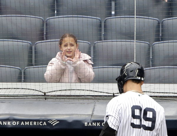 New York Yankees Aaron Judge walks back to the dug out after being left in the on deck circle to end the third inning ag