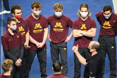 April 17, 2021, Minneapolis, Minnesota, U.S: Gymnasts from the University of Minnesota listed to head coach MIKE BURNS b
