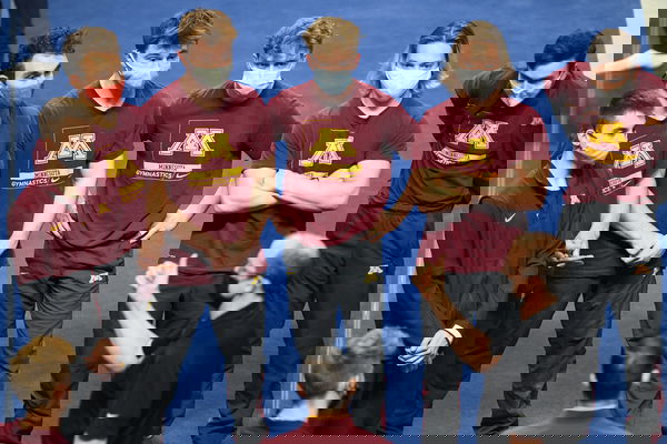 April 17, 2021, Minneapolis, Minnesota, U.S: Gymnasts from the University of Minnesota listed to head coach MIKE BURNS b