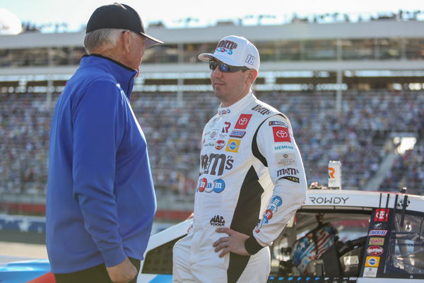 CHARLOTTE, NC &#8211; MAY 30: Kyle Busch, driver of the 18 M&amp;M&#8221;!s Red, White and Blue Toyota, talks with team owner Joe Gibbs b