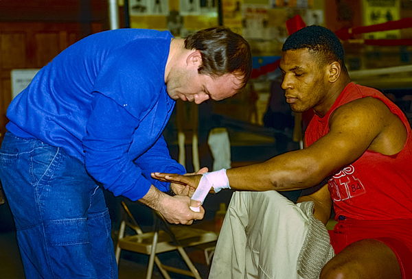 Boxing Mike Tyson Mike Tyson getting his hands wrapped by trainer Kevin Rooney at Cus D Amato s gym in Catskill, NY in 1