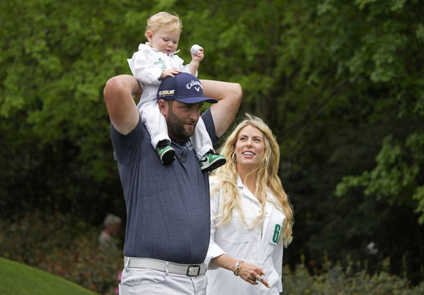 Jon Rahm of Spain holds his son Kepa as he and his wife Kelley compete in the Par 3 Contest at the Masters golf tourname