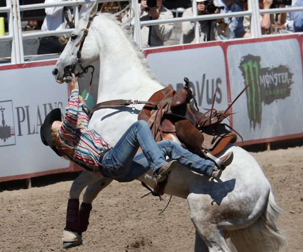 Calgary, Alberta; Canada&#8212; Cowgirl Lois Ferguson (from West, Texas) is thrown from her horse during the Ladies Barrel Racing