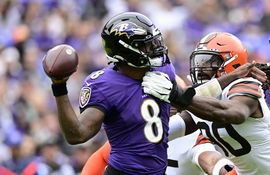 Baltimore Ravens quarterback Lamar Jackson (8) is pressured by Cleveland Browns defensive end Jadeveon Clowney (90) duri