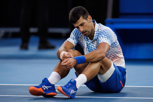 Tennis: Australian Open Jan 21, 2023; Melbourne, Victoria, Australia; Novak Djokovic of Serbia falls over during his mat