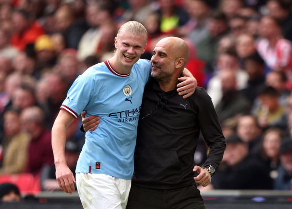 Erling Haaland (MC) and Pep Guardiola (Man City manager) hug at the Emirates FA Cup Semi-Final Manchester City v Sheffie