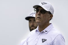 June 13, 2023, Los Angeles, California, USA: Golfers Phil Mickelson (right) and Jon Rahm (left) watch a member of their