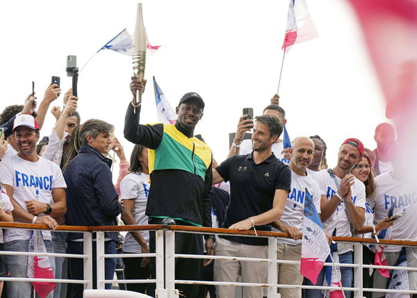 Paris 2024 Olympics ceremony Retired Jamaican sprinter Usain Bolt (C, L) holds an Olympic torch for the Paris 2024 Olymp