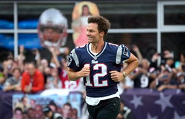 Syndication: The Providence Journal Former New England Patriots quarterback, Tom Brady, runs on to the field at Gillette