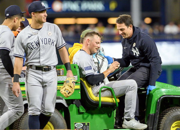 New York Yankees relief pitcher Anthony Misiewicz (54) looks at the baseball that hit the side of the head as he is cart