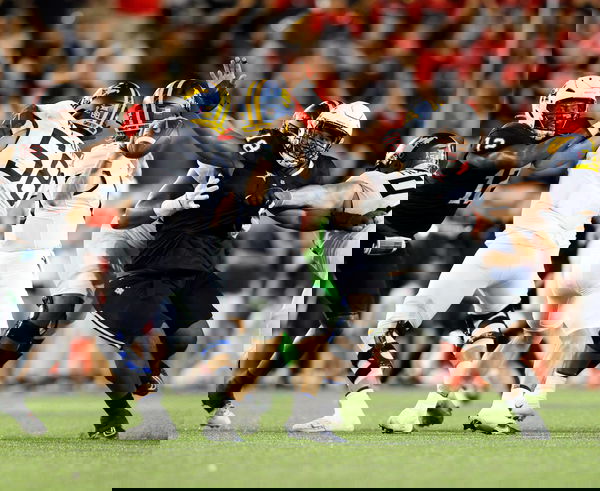 October 12, 2023: Houston defensive lineman Anthony Holmes Jr. (18) attempts to block a pass by West Virginia quarterbac