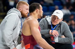 Syndication: Hanover Evening Sun Coaches Cael Sanderson (right) and Bo Nickal (right) talk with Aaron Brooks between per