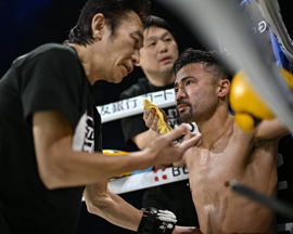 Challenger Japan s Daigo Higa, right, receives treatment from his trainer Joji Nogi before the fourth round during the W
