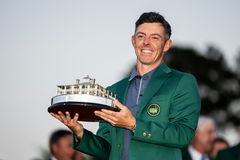 250413 Rory McIlroy of Northern Ireland poses with the Masters trophy during the Green Jacket Ceremony after winning the