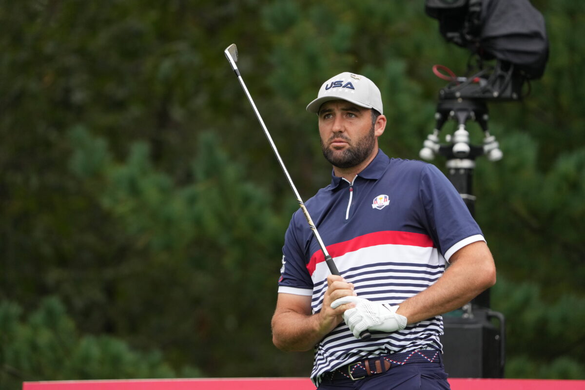 Scottie Scheffler of Team USA looks after hitting a shot