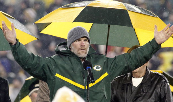 Former Green Bay Packer quarterback Brett Favre reacts to the crowd as his number is retired during