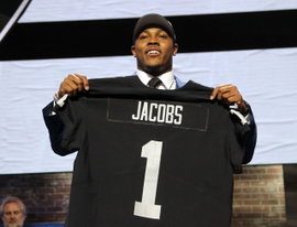 Josh Jacobs from Alabama State holds up a jersey after being picked 24th over all by the Oakland Ra