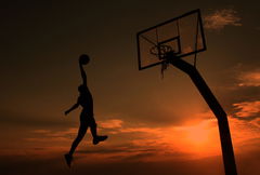 Young man is playing basketball during sunset, This young man is playing basketball during sunset. m