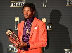 Lamar Jackson of the Baltimore Ravens holds the Most Valuable Player Award at the NFL Honors program during Super Bowl