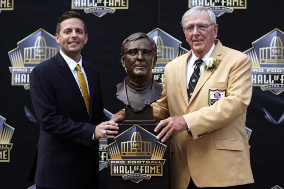 Ron Wolf, right, poses with a bust of him and with his presenter and son, Eliot Wolf, during the induction ceremony at the Pro Football Hall of Fame, Saturday, Aug. 8, 2015, in Canton, Ohio. Wolf, the man who brought Brett Favre to Green Bay, beat the quarterback to Canton. Wolf led off the eight-man Pro Football Hall of Fame Class of 2015. (AP Photo/Gene J. Puskar)(Gene J. Puskar)
